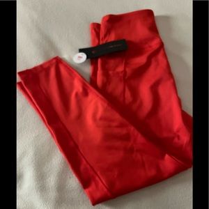 Size M, bright orange yoga capris.  NWT. Never worn.